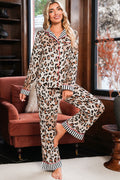 Woman wearing leopard print pajamas with striped cuffs in a cozy living room.