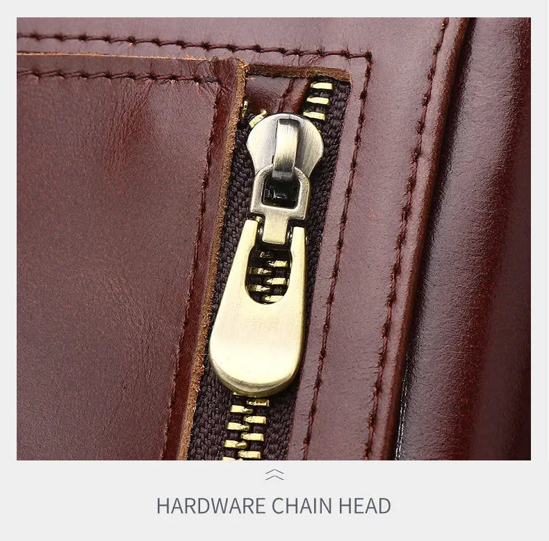 Close-up of a gold zipper chain head on brown leather