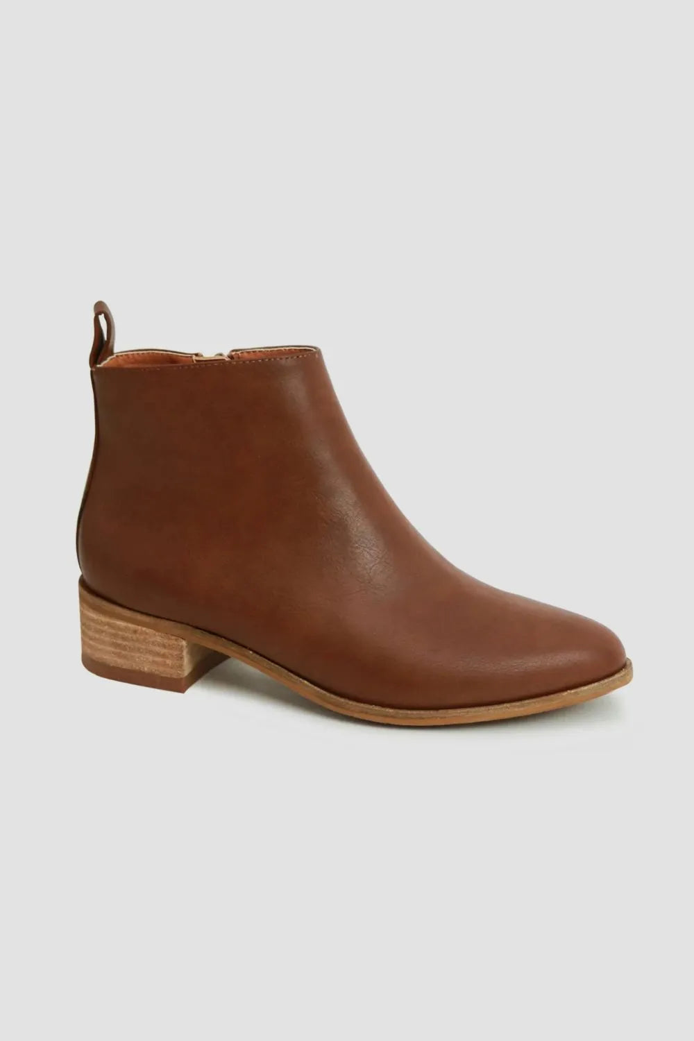 Brown ankle boot on a light gray background