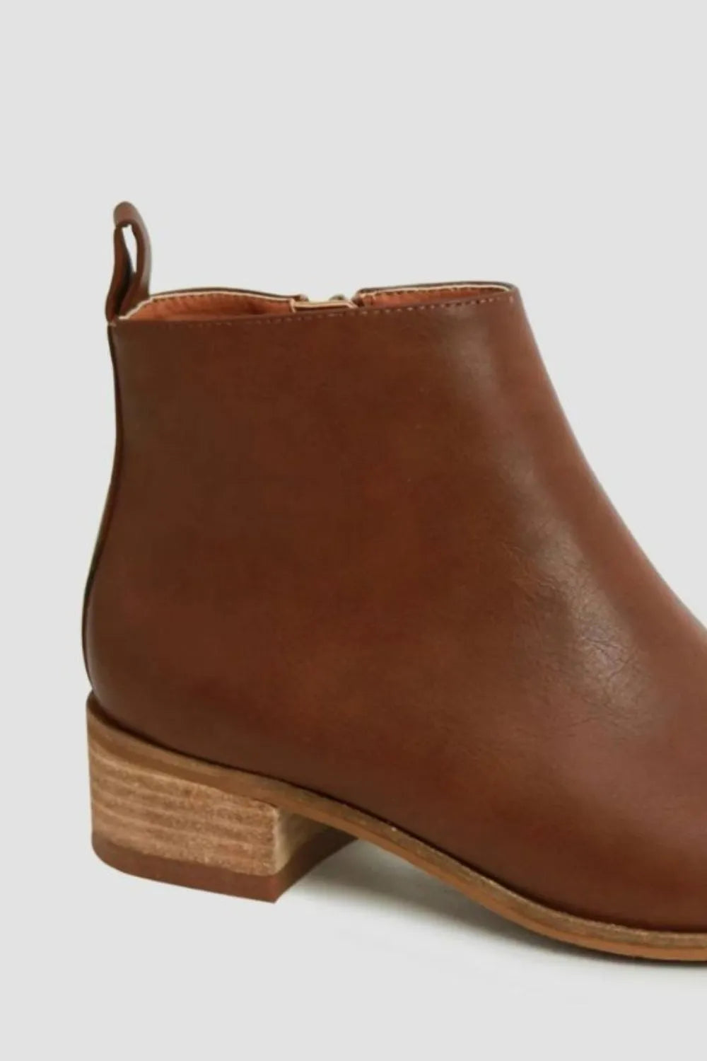 Brown ankle boot on a light gray background