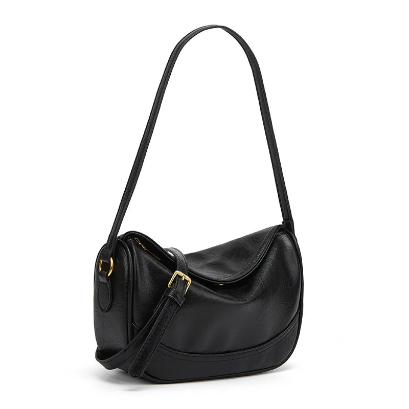 Minimalist crescent hobo shoulder bag in neutral tones styled as a quiet luxury accessory by The PM Edit.