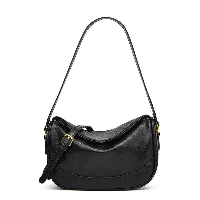 Minimalist crescent hobo shoulder bag in neutral tones styled as a quiet luxury accessory by The PM Edit.