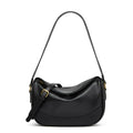 Minimalist crescent hobo shoulder bag in neutral tones styled as a quiet luxury accessory by The PM Edit.