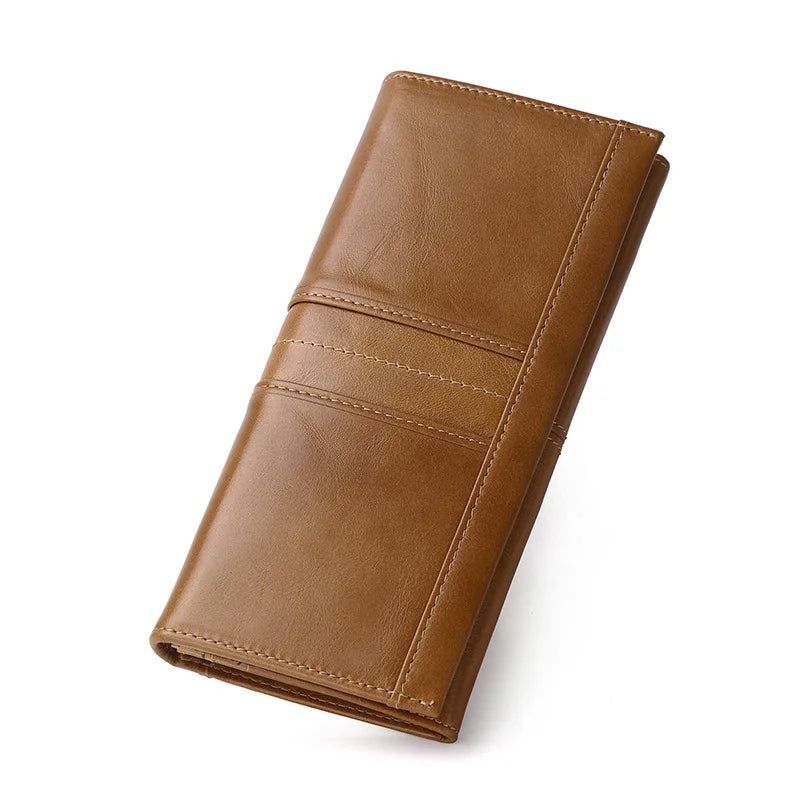 A brown leather long wallet shown at an angle on a plain white background.