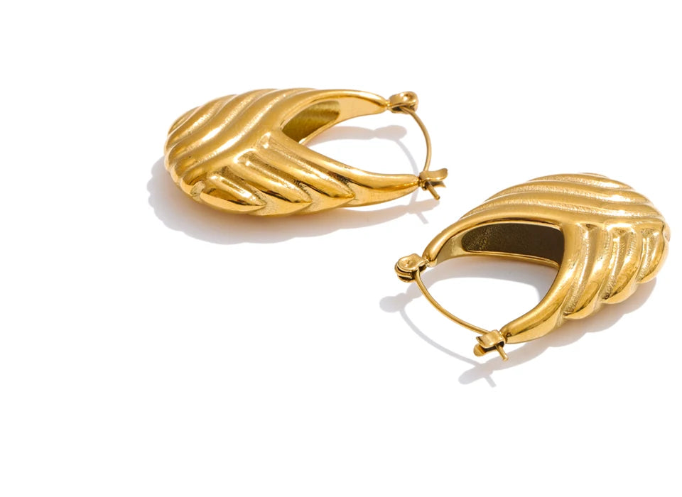 Gold hoop earrings on a white background