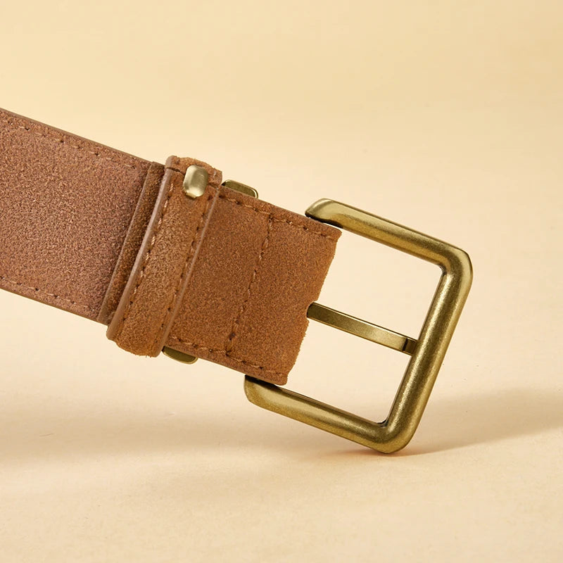 Brown leather belt with brass buckle on a beige background