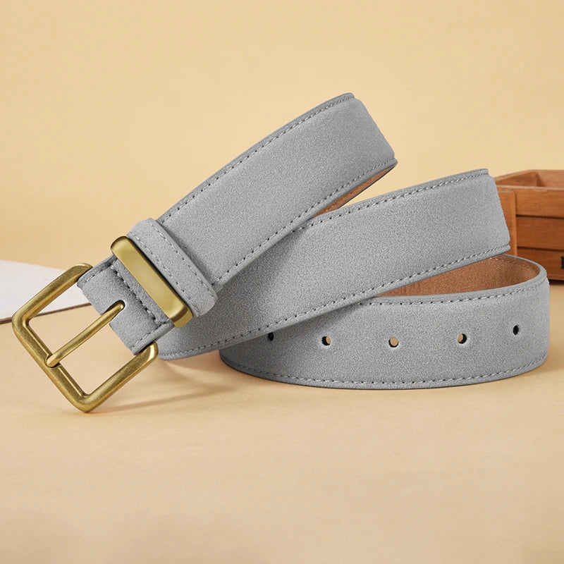 Gray belt with a gold buckle on a beige background