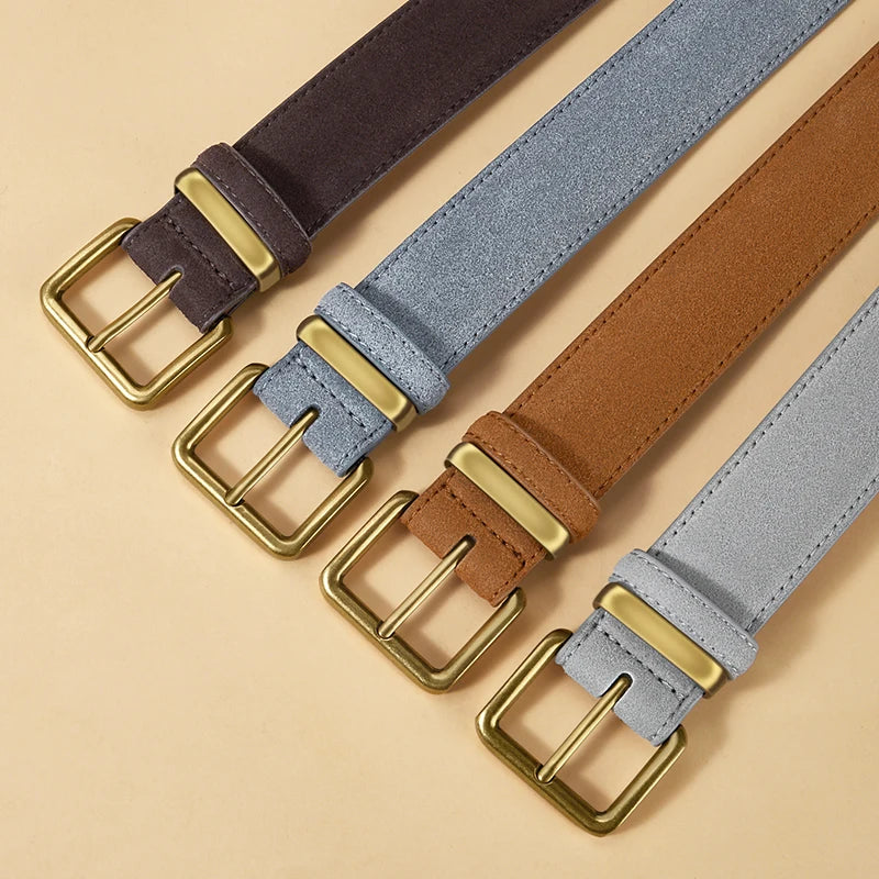 Four belts with gold buckles on a beige background