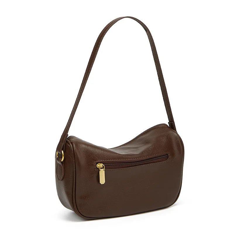 Minimalist crescent hobo shoulder bag in neutral tones styled as a quiet luxury accessory by The PM Edit.