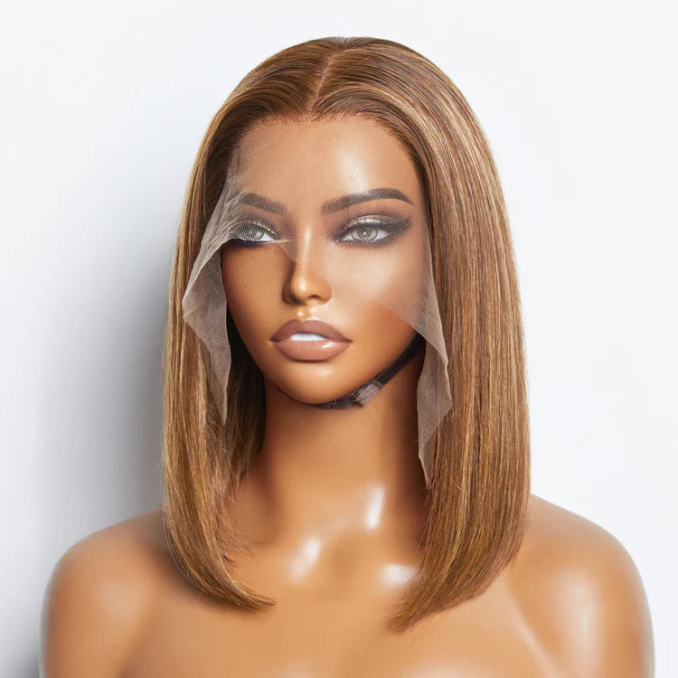 Mannequin head with a brown bob wig on a white background