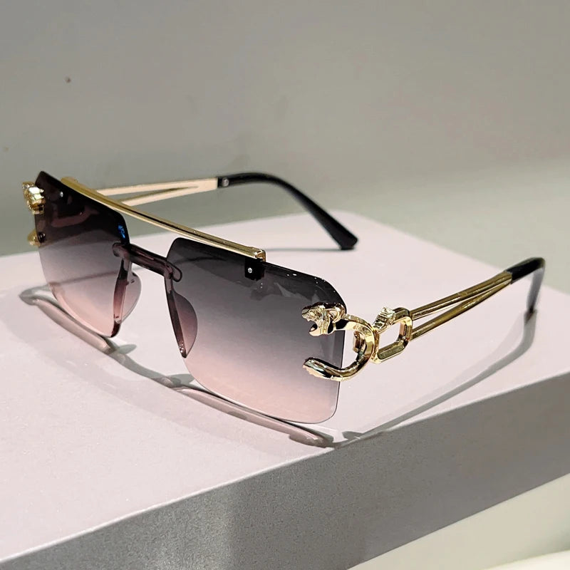 Sunglasses with gold frame and gradient lenses on a reflective surface