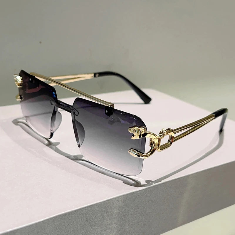 Sunglasses with gold frame and gradient lenses on a light surface