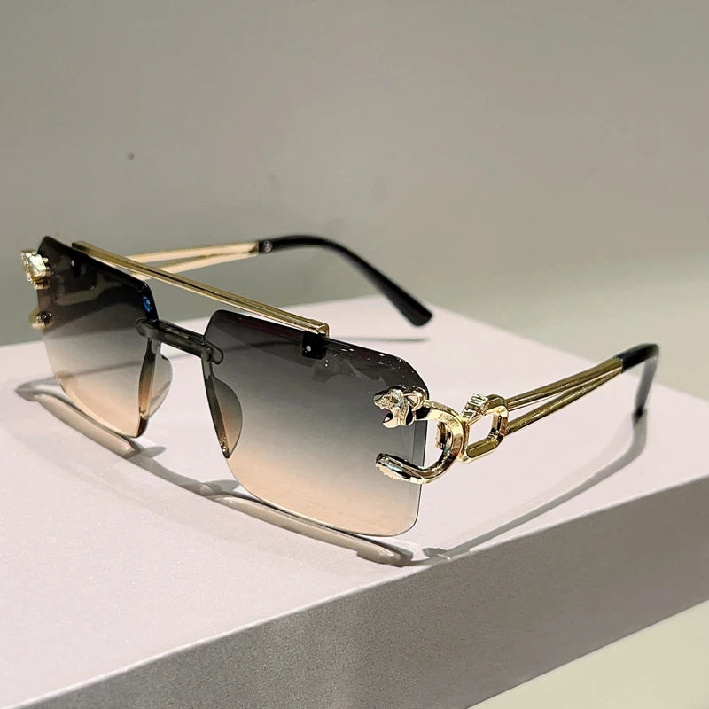 Sunglasses with gold frames and gradient lenses on a light surface