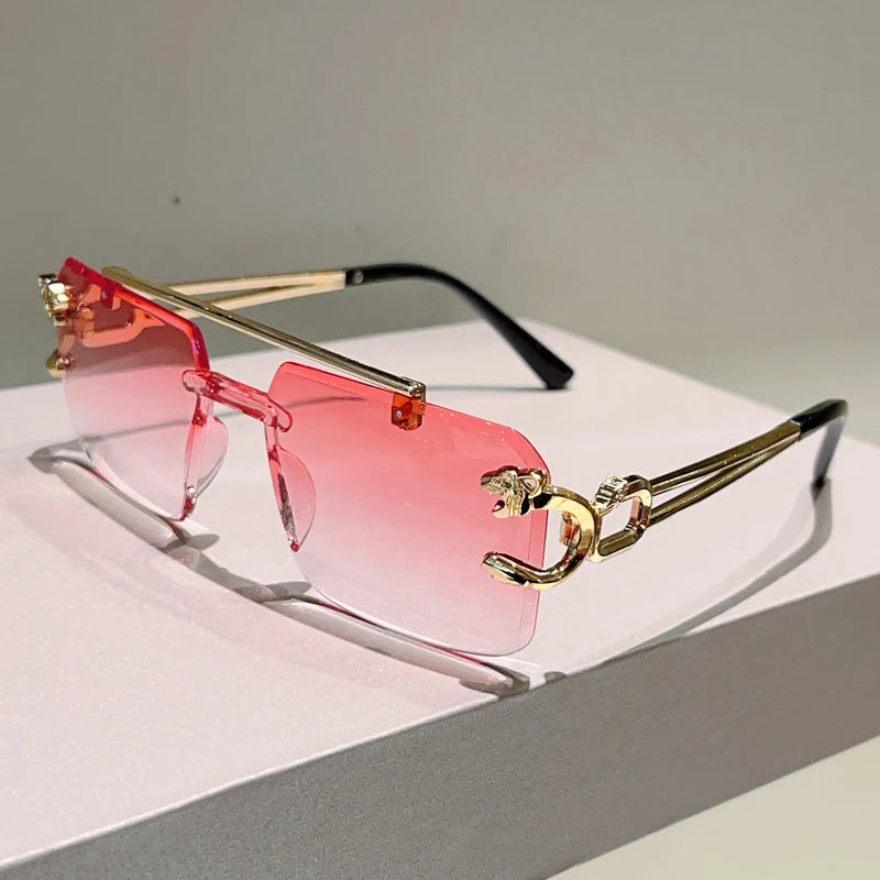 Sunglasses with pink lenses and gold frames on a light surface