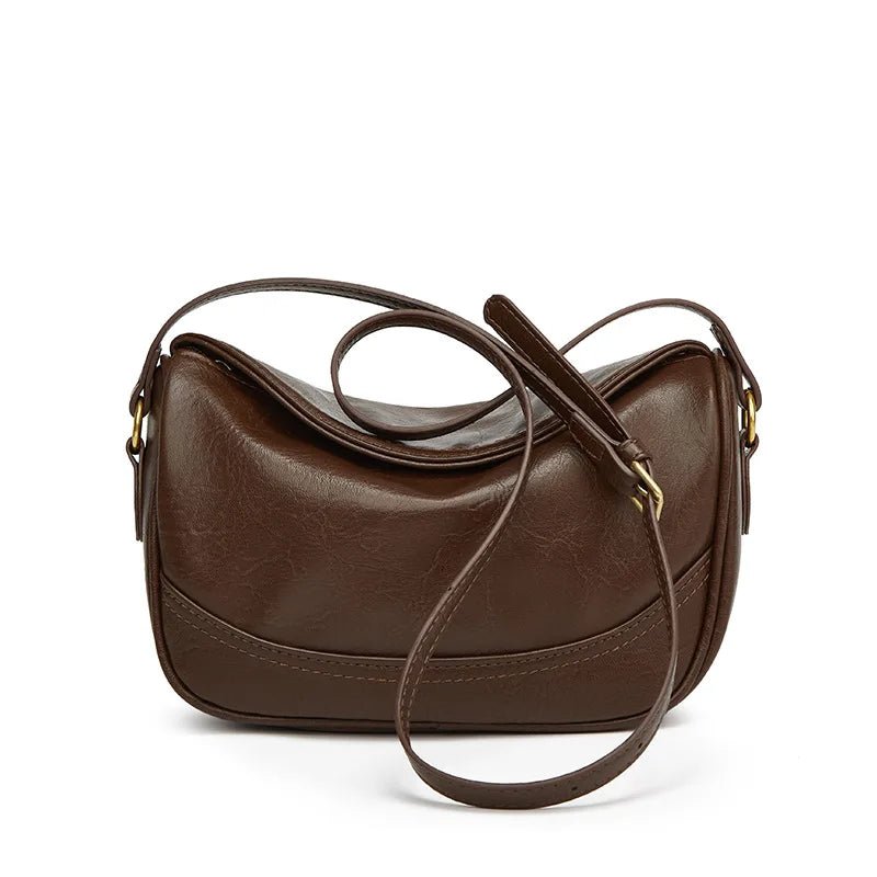 Brown leather handbag with a shoulder strap on a white background