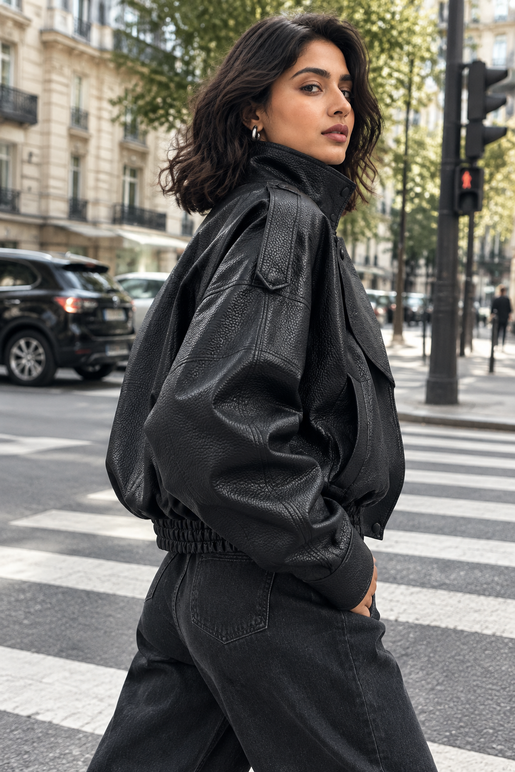 •  A professional model wearing a tailored wardrobe separate layout styling the matte black pebble leather jacket open to showcase a clean day-to-night lifestyle transition.
Low three-quarter jacket angle