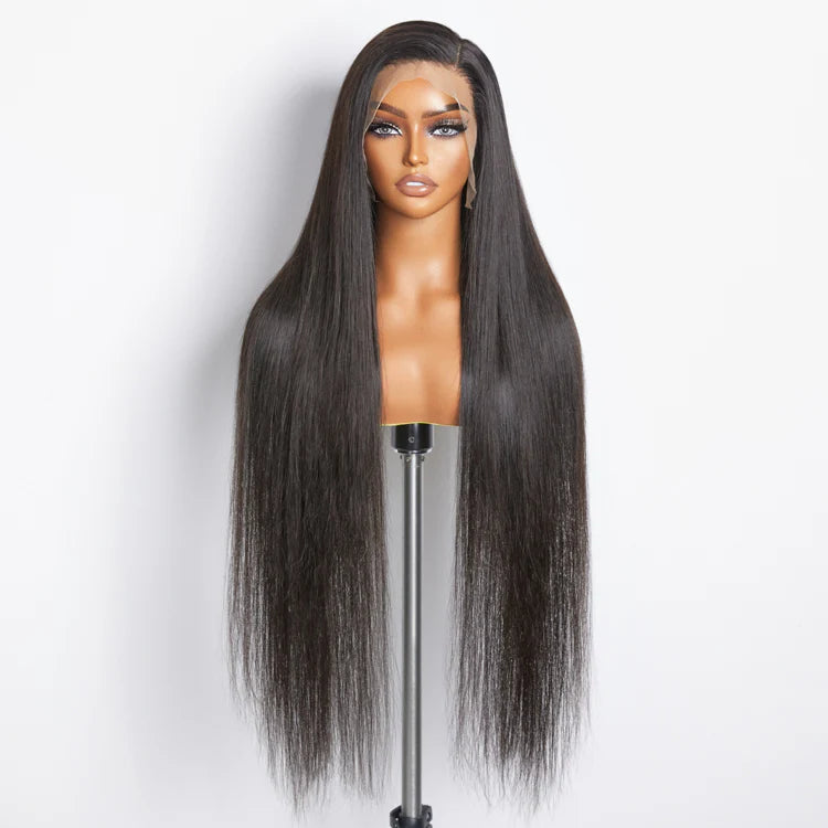 Long black straight wig on a mannequin head against a white background