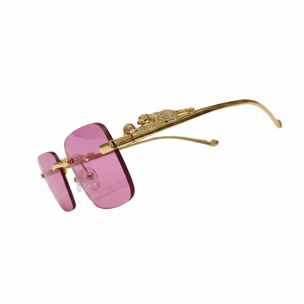 Gold-framed rimless sunglasses with pink tinted lenses and a decorative lion emblem on the temple arm, shown against a plain white background.