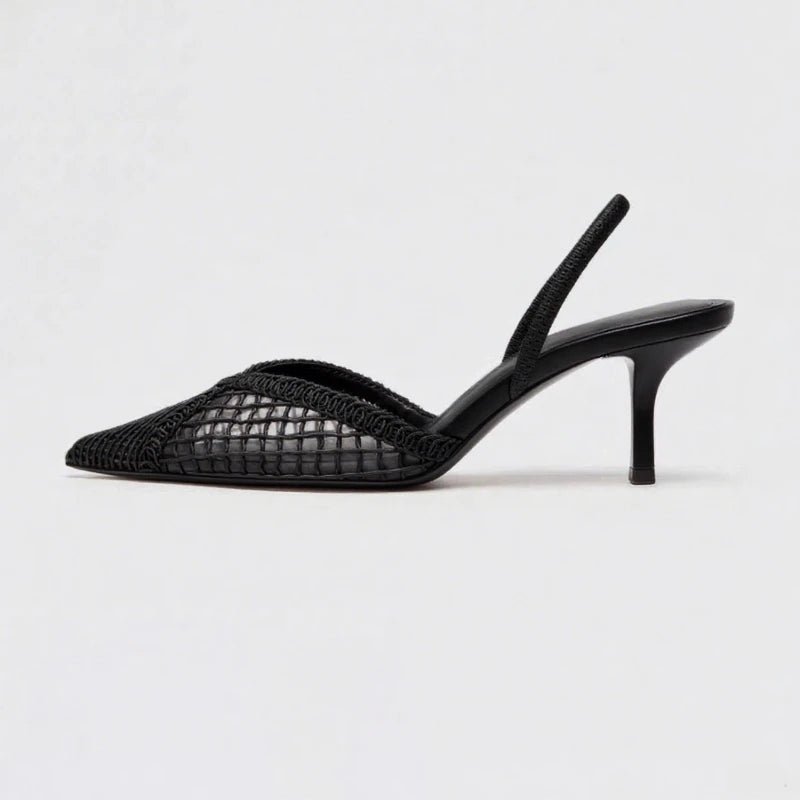 Black woven sandal with a high heel on a light gray background