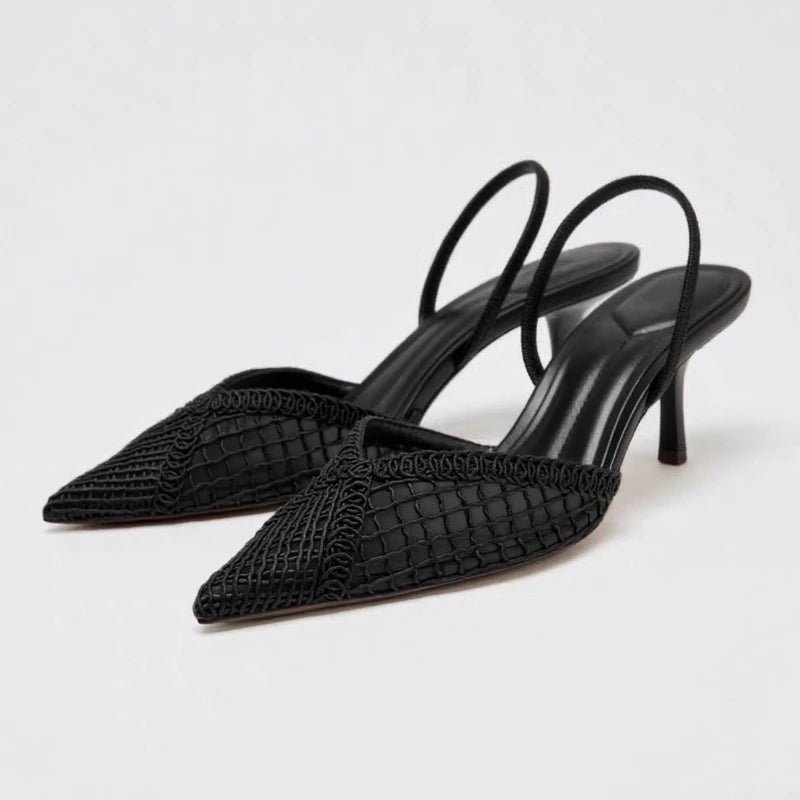 Black woven high-heeled shoes on a light gray background