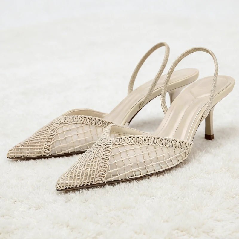 Pair of beige high-heeled shoes with woven detailing on a light background