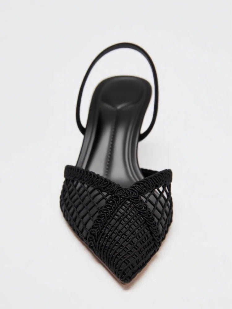 Black pointed-toe sandal with mesh design on a white background