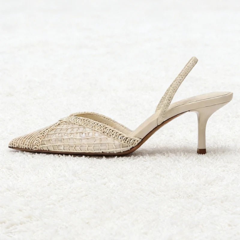 Beige high-heeled shoe on a textured white surface