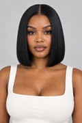 A woman with a straight, shoulder-length black bob wig is shown from the chest up against a light gray studio background. She is wearing a white square-neck top.