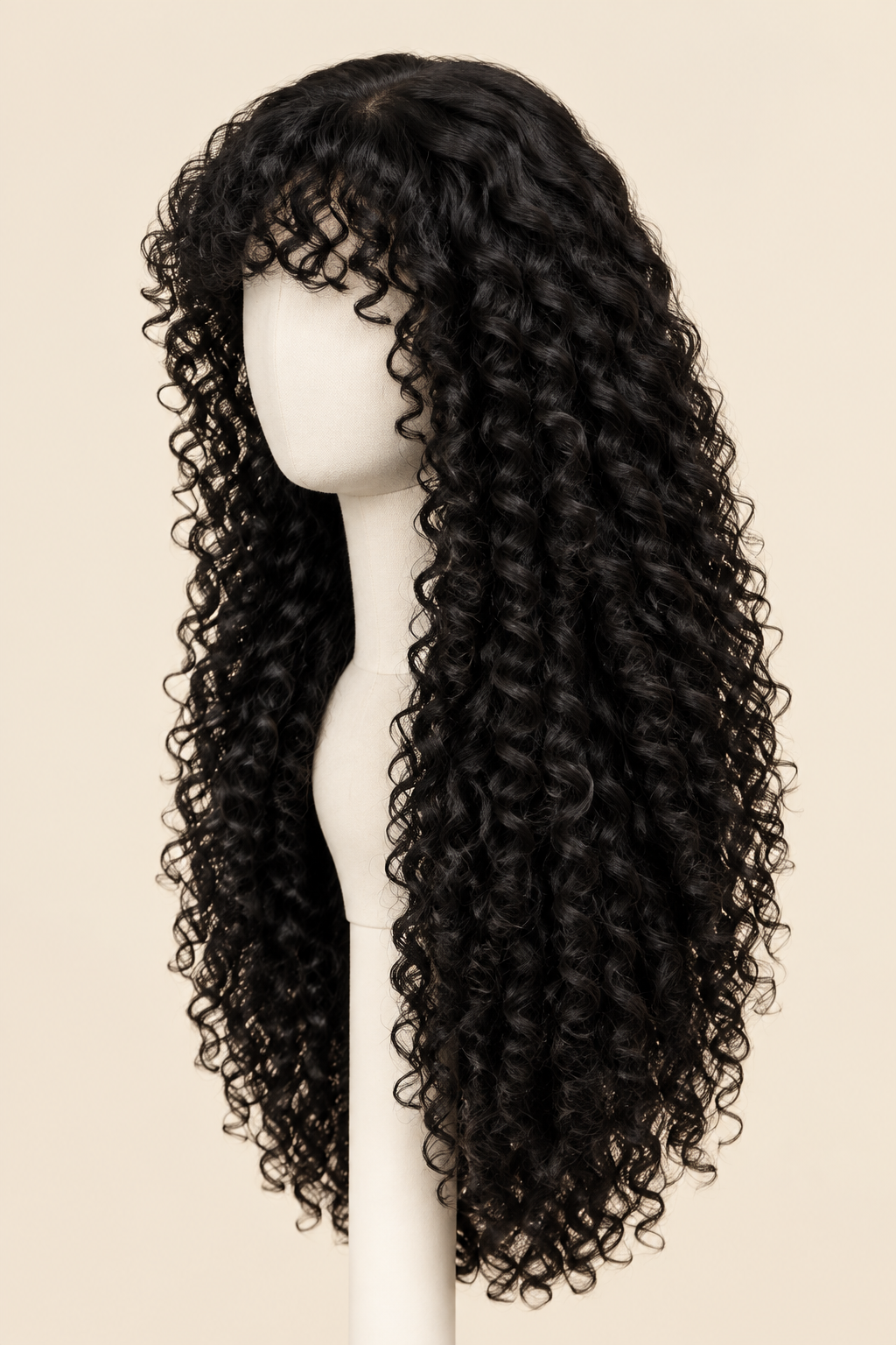 A long black curly wig with bangs displayed on a white mannequin head against a light beige background.