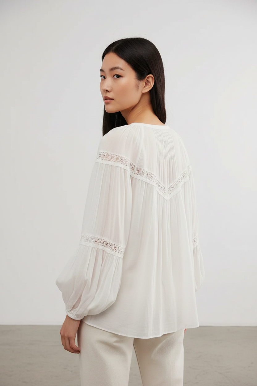 White sheer lace-trim balloon-sleeve blouse shown from the back