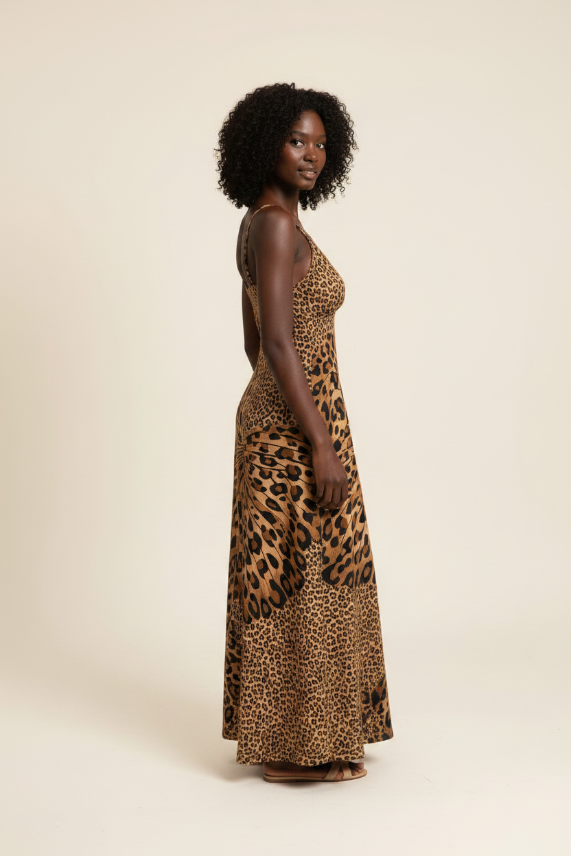 Side view of a model wearing a leopard-print maxi cami dress with a butterfly motif