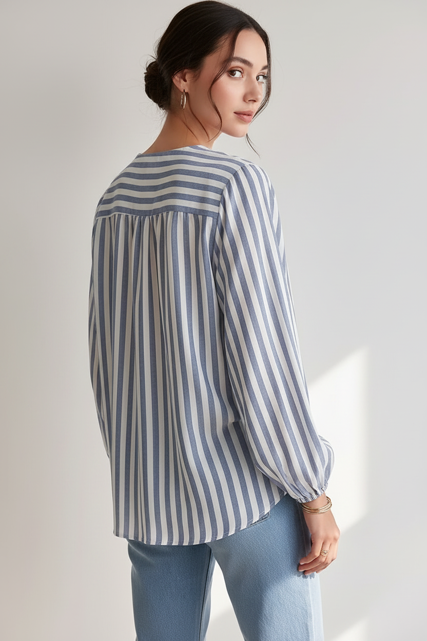Back view of a model wearing a dusty blue and white striped long-sleeve blouse