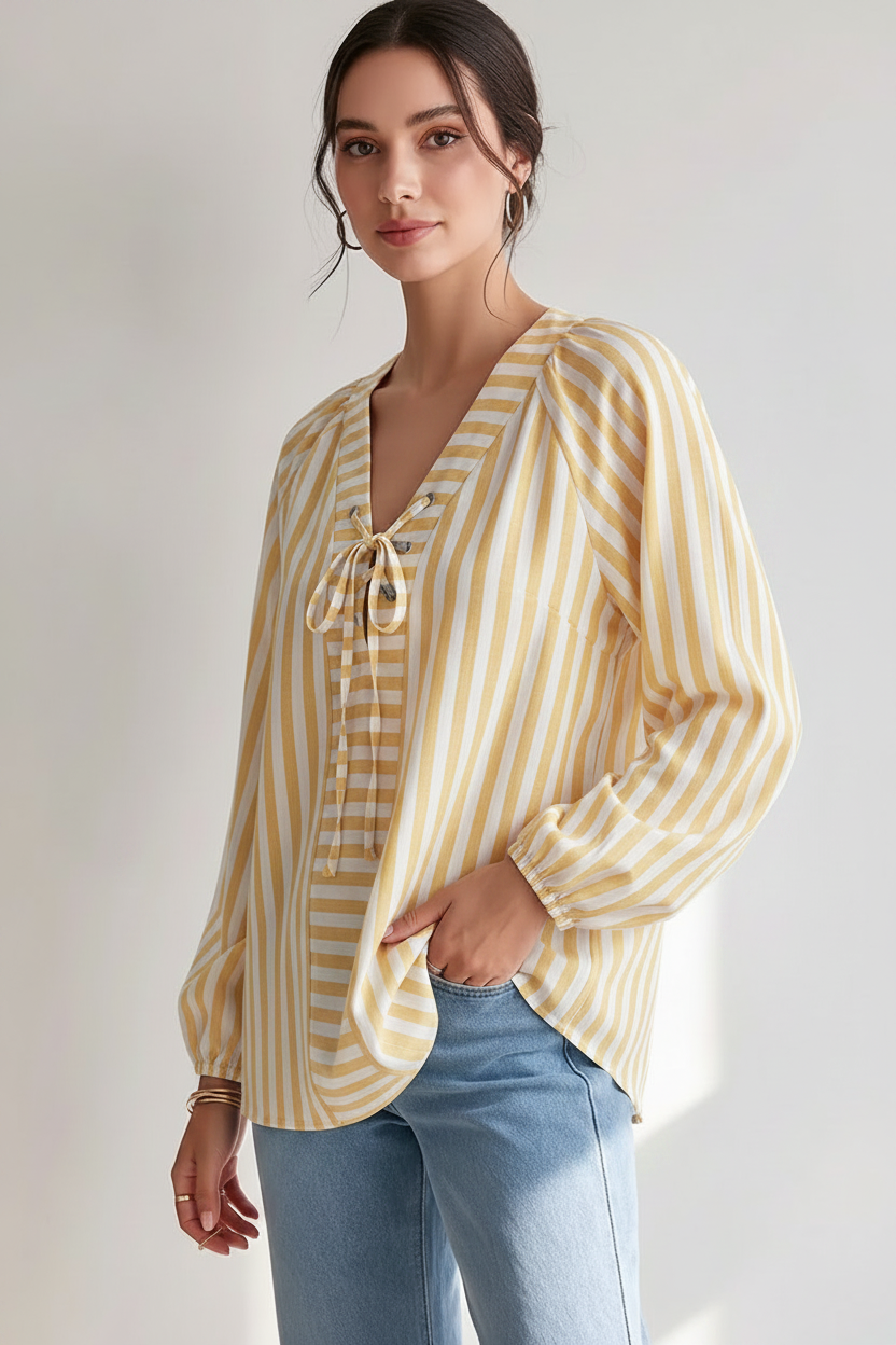 Model wearing a pastel yellow and white striped tie-front blouse with long sleeves