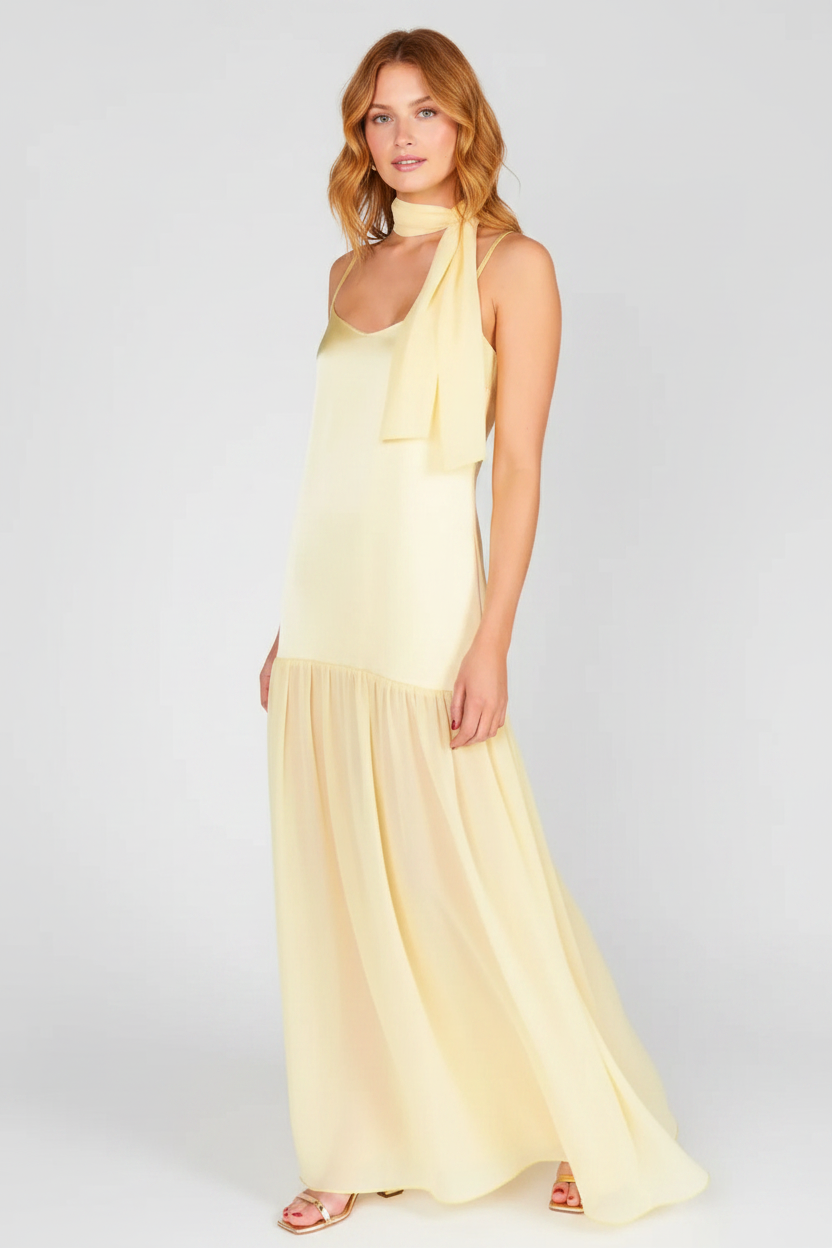 Model wearing the pastel yellow adjustable-strap maxi cami dress with its matching short scarf