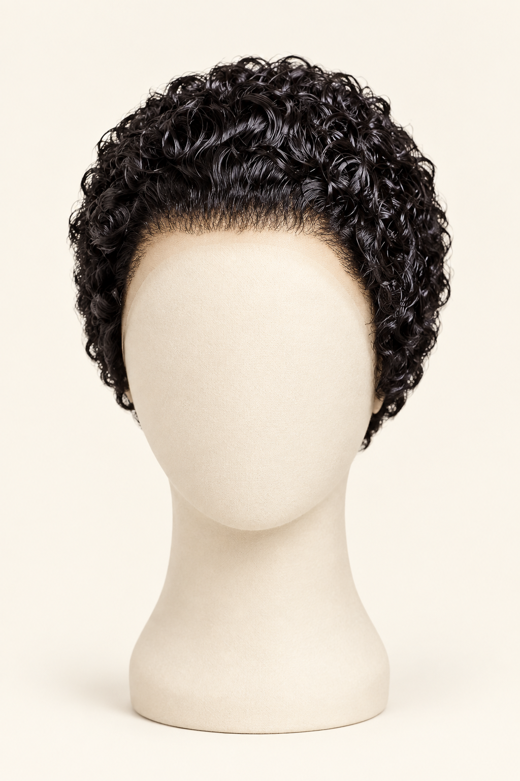 Short curly black wig displayed on a cream mannequin head against a light beige studio background.